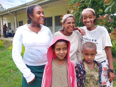 Tigist and her family smiling