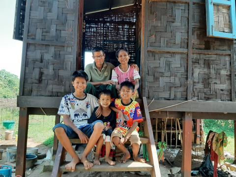 Htet and his family in front of the new house (Htet is at the right corner of front row)