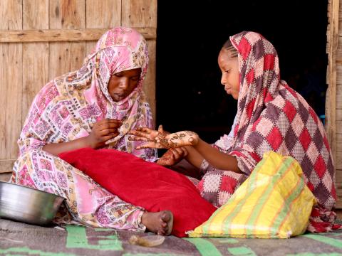 two young girls preparing themselves for Henna night