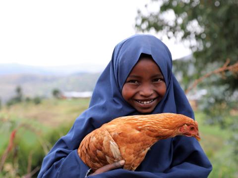Sabontu holding chicken