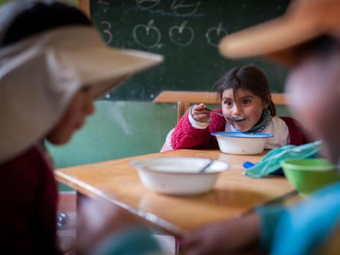 Herlinda, 4, eats lunch at Cotuhuma elementary school in Soracachi, Bolivia.