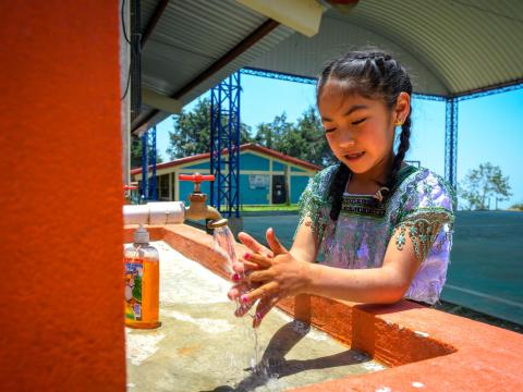Girl in Guatemala washing her hands