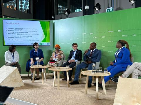 McLanrence (holding microphone) AT COP28