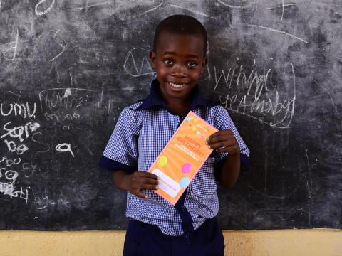 A child holding the BBB cards