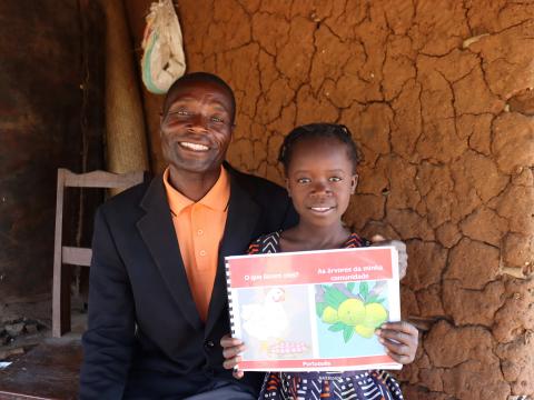 Belucha on the right exhibits one her books used for reading competition. 