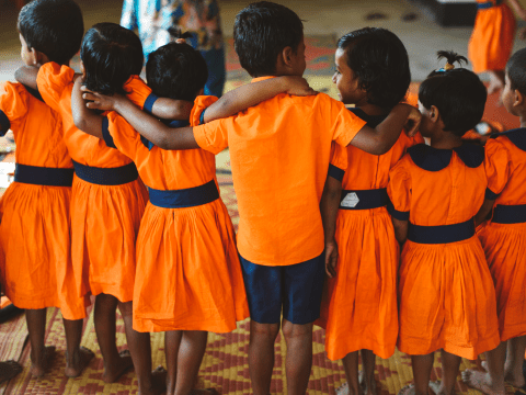 children shoulder to shoulder