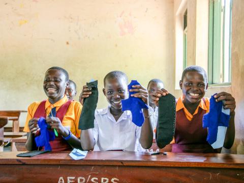 girls displaying her reusable menstrual hygiene kit