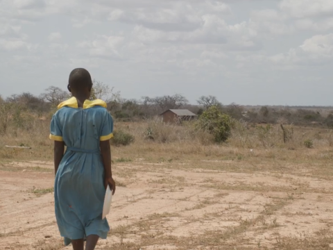 Faith, 15, looks out over a desolate stretch of drought-stricken land in Bamba, Kenya