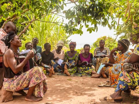 Dame Mukeni discussing with other members in their saving group