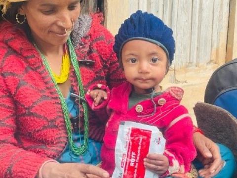 A child holds a ready to eat packet