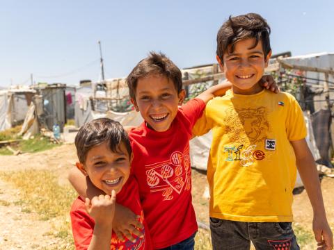 three siblings hugging and smiling 