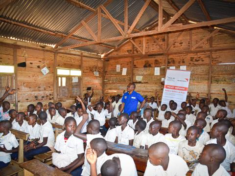 Deogratias with pupils in a sensitisation session