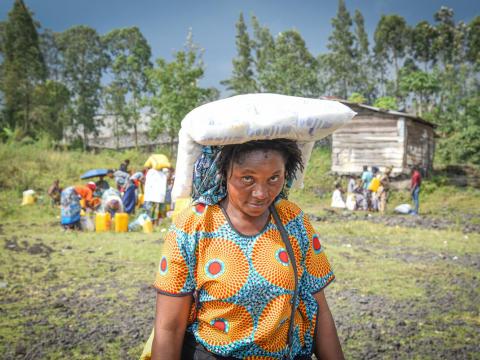 A woman assisted with food aid as disaster response