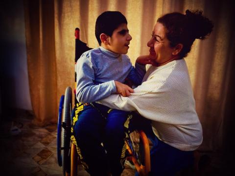 A child with disability and his mother from Iraq