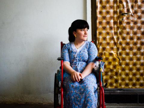 A little girl from Iraq sitting in her wheelchair