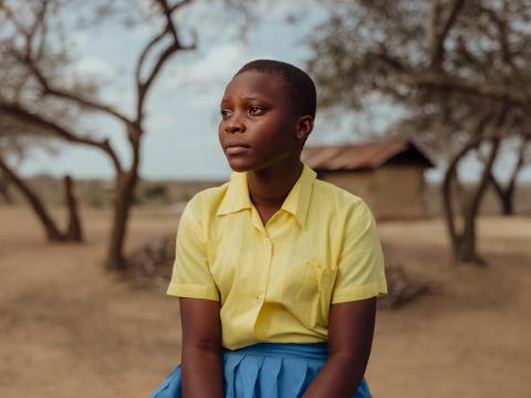 Faith, 15, looks out across a landscape in Bamba, Kenya. 