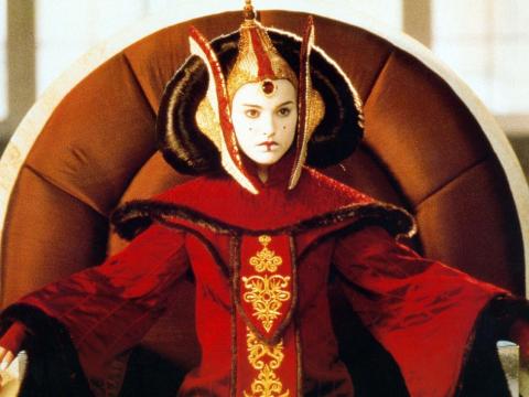 Queen Amidala from the Star Wars franchise sits on a throne