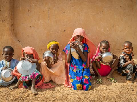 Sudanese refugee children at a World Vision school feeding program in Farchana Refugee Camp, Chad.