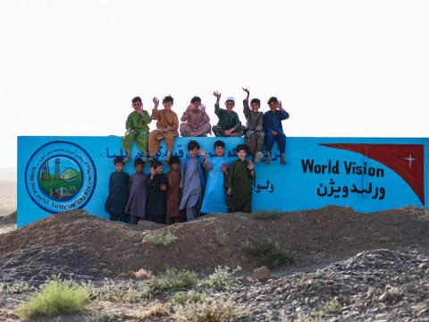 Afghan children waving to the camera