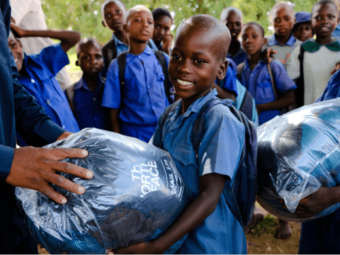 A child receives a sleeping bag with joy