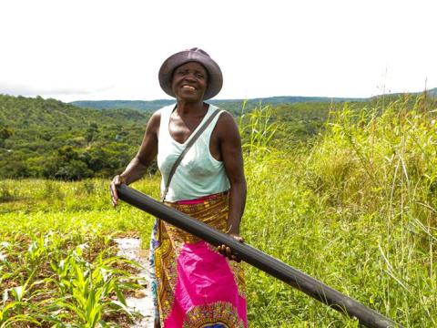 Emelia Makirambo demonstrating how they use flood irrigation