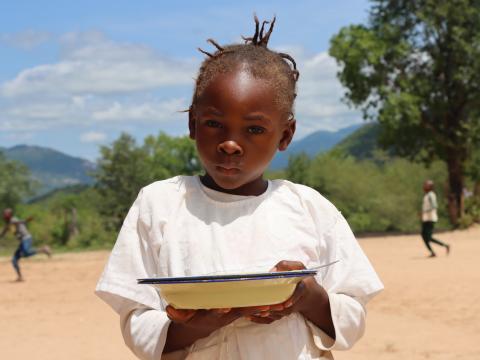 Girl holding a plate of food