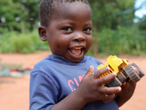 Delcio smiles brightly after recovering from malnutrition