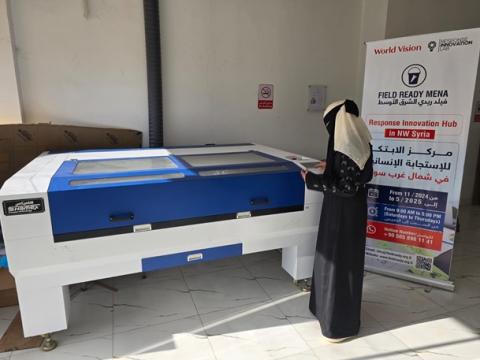 Layal using WVSR's laser cutting machine at the World Vision Innovation Lab