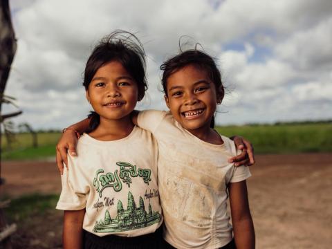 two girls from Cambodia happily looking at the camera