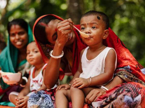 Mother feeding child in Bangladesh