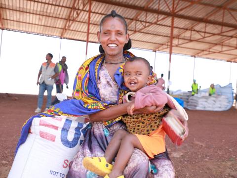 Naney and her child at the distribution center