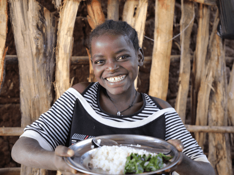 A child holding a meal at school