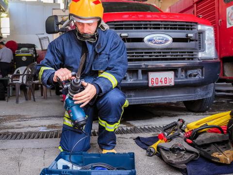A Palestinian firefighter is trained to use new tools to respond to emergencies