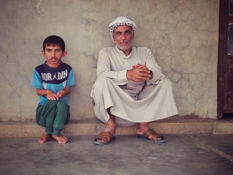Mahran and his father at their home in Rashad. Ziryan Kameran© World Vision