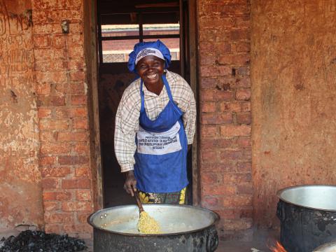 Jina cooking for pupils at Kakombo primary school