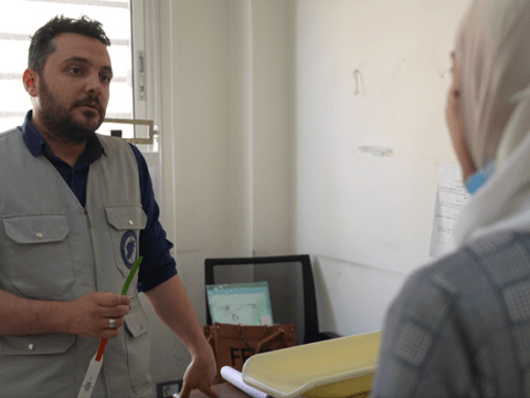 A photo of one of the specialised staff at the hospital providing support to a patient . 