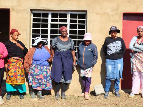 Members of Mahamba Piggery stadning outside a structure they have built to use as their offices.