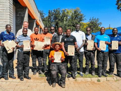 Rose (sitting) with her training counterparts and trainers from the Global Fleet after receiving their certificates