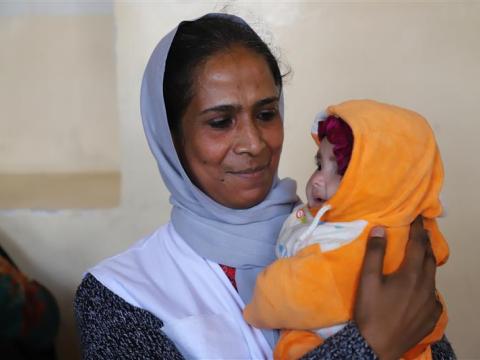 Asuntha holding a baby