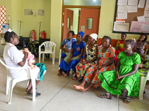 Midwife demonstrates exclusive breastfeeding to pregnant women in Uganda