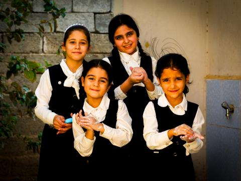 Children in Iraq washing hands