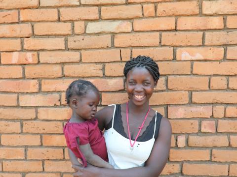 Rosita smiles and holds her daughter Gilda