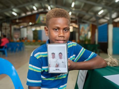 Francis with photo of his sponsors