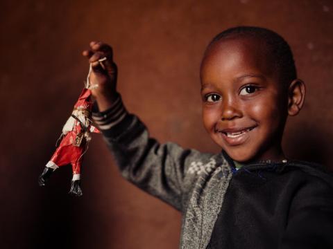 A child showing his Christmas ornament 
