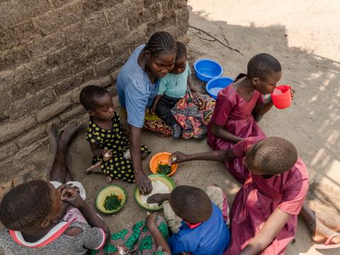 Mother feeding her 6 children