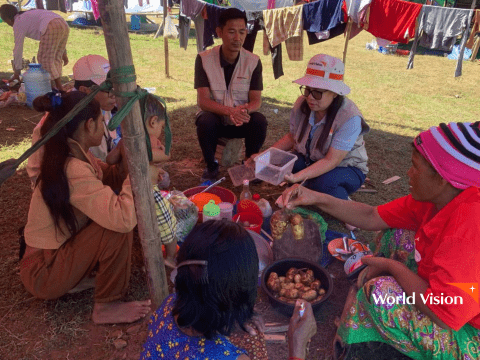 Sharing what little remains: displaced families with the food they carried from home.