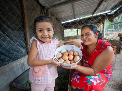 Rocío, 4, and her mother Ada collect eggs from their Gift Catalog chickens.