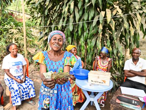 A member of a saving group showing her money