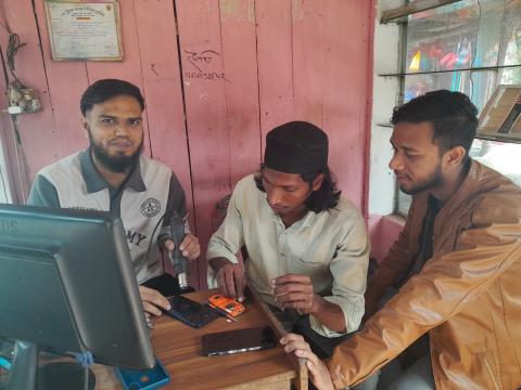 Ifty providing service for customers at his shop