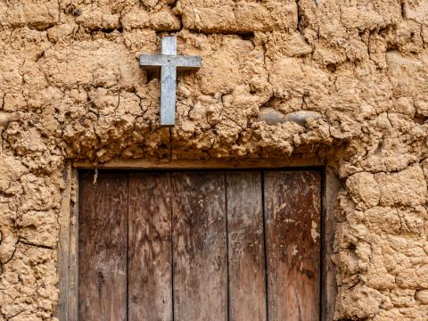 A wooden cross above a doorway 